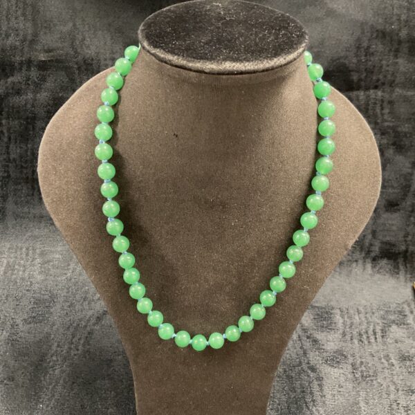 Antique hand-knotted jade necklace with gilt clasp, 18 inches long.