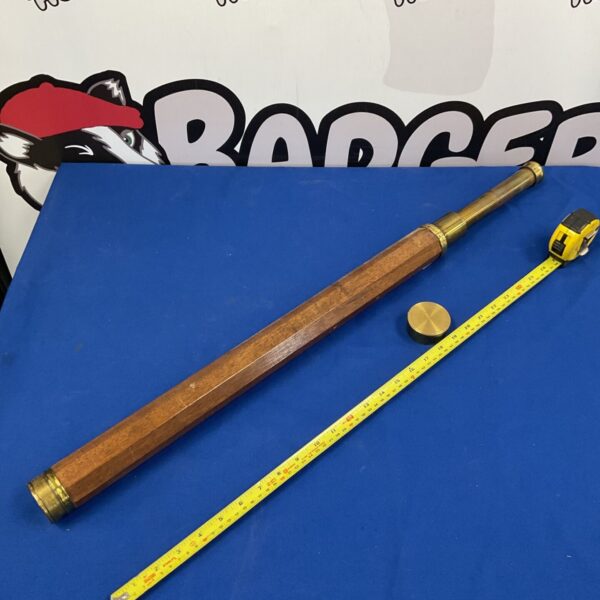 Antique mahogany telescope with brass draw tube and measuring tape.