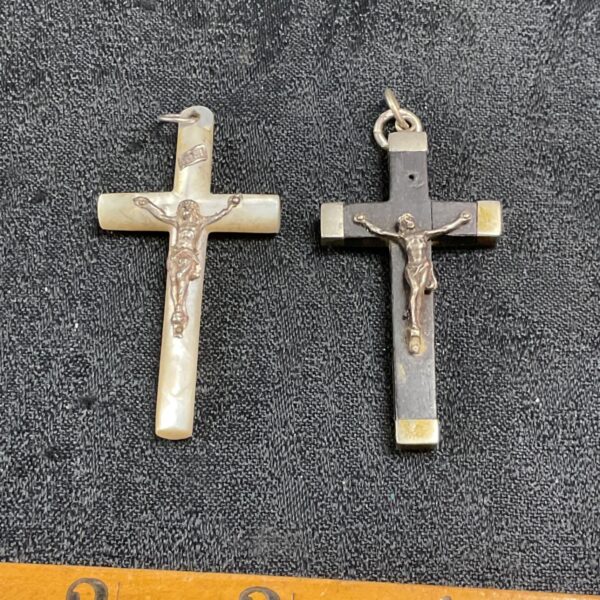 Antique mother of pearl crucifix pendants with detailed carving.