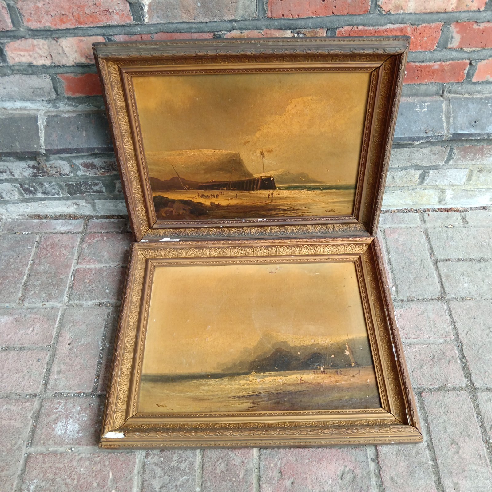 Antique oil painting of a seascape with a gilt frame.