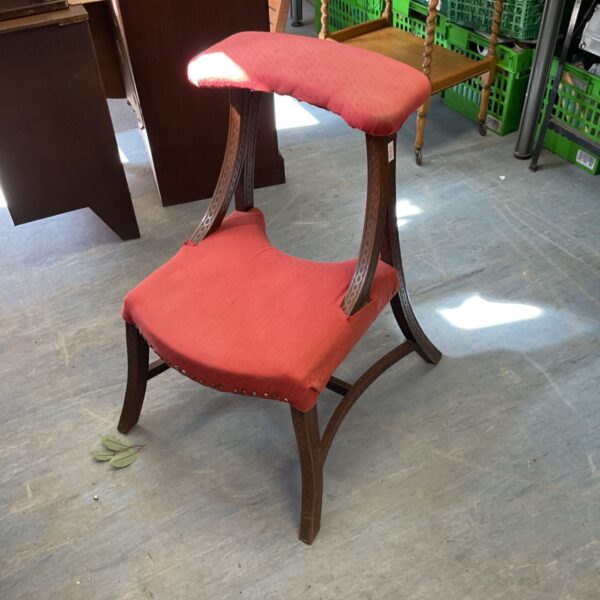 Antique red upholstered prayer chair, Victorian religious seating.
