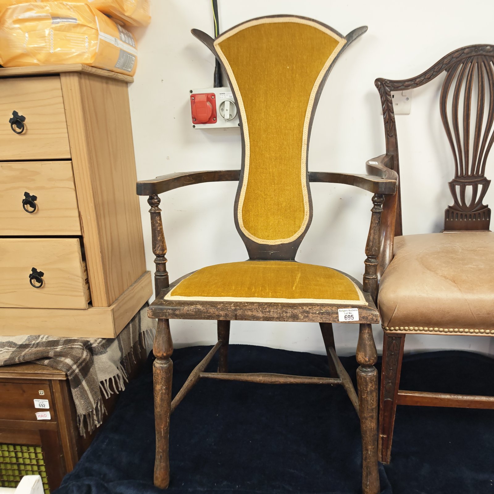 Antique yellow upholstered shield back armchair, vintage furniture.
