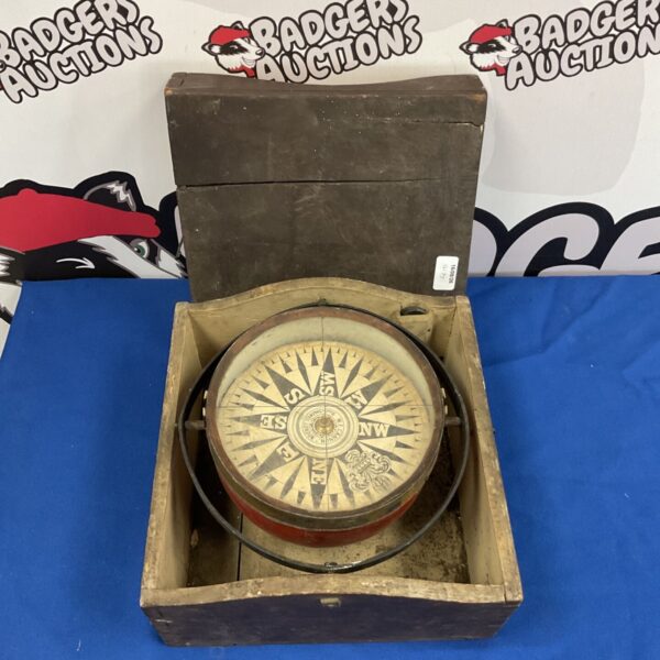 Antique ships compass in wooden case, nautical instrument.