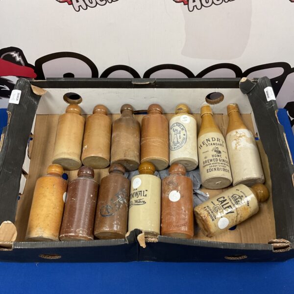 Antique salt glazed stoneware bottles including Hendry Standard and Caley.