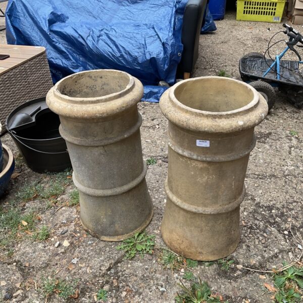 Antique stoneware chimney pot, weathered and repurposed as a garden planter.