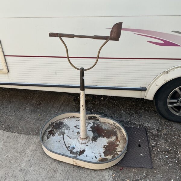Antique toleware bird stand with distressed paint and brass perch.