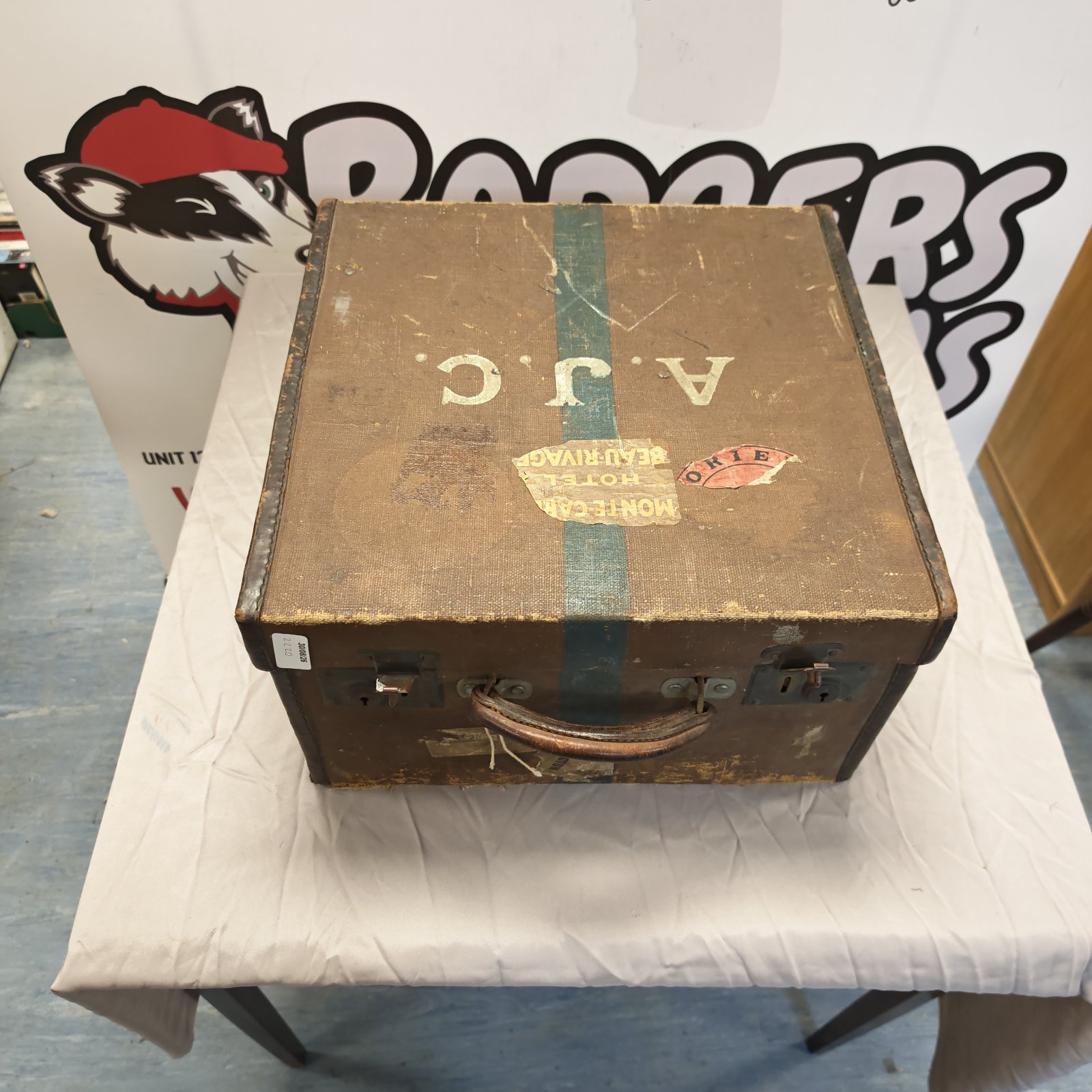 Antique travel trunk initialed A.J.C., vintage luggage collectible.