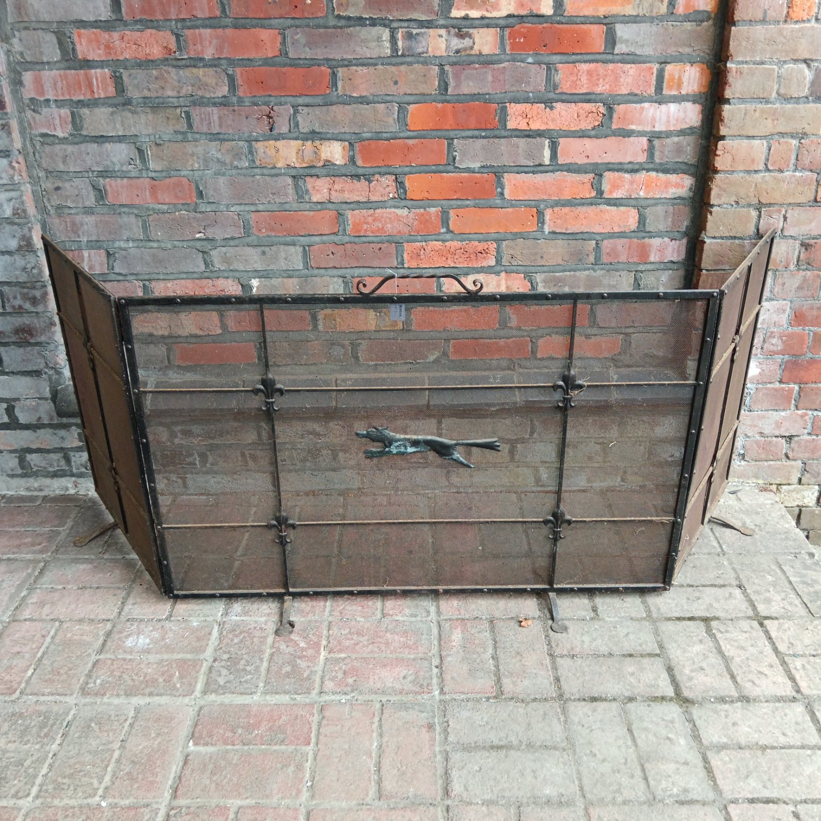 Antique wrought iron fire screen with fox and Fleur de Lis details.
