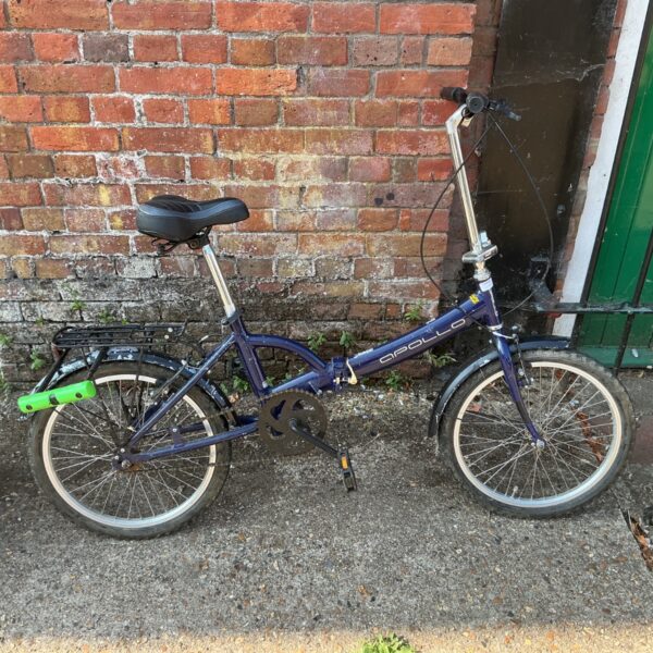 Blue Apollo folding bike with rear rack and mudguards.