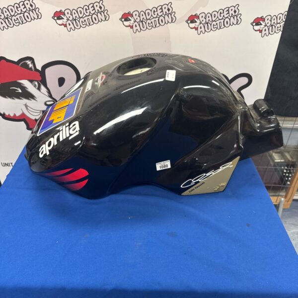 Black Aprilia fuel tank with Colin Edwards racing graphics.