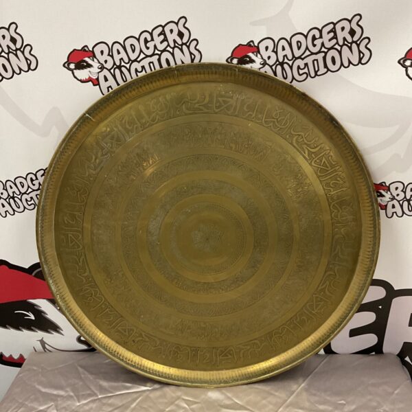 Large Arabic brass charger with intricate embossed design.