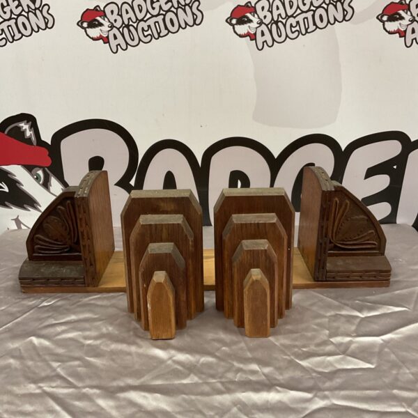 Vintage art deco oak bookends on a dark surface.