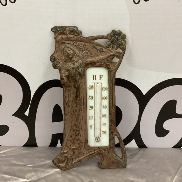 Vintage art nouveau barometer with mercury tube and floral design.