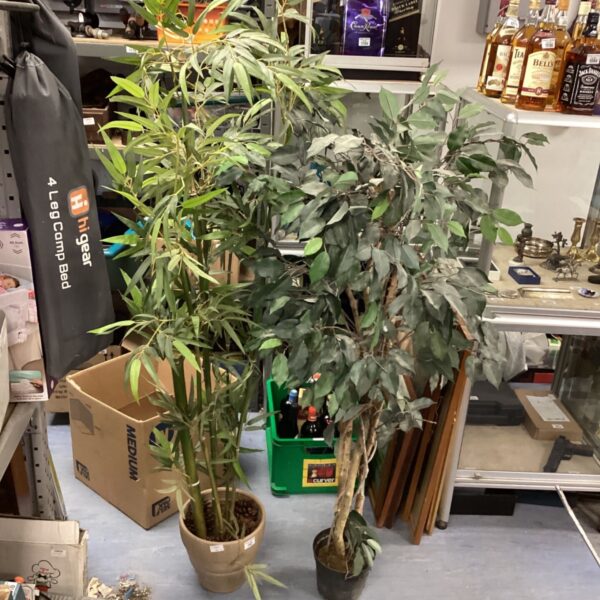 Two artificial plants, including a bamboo, in pots for home decor.