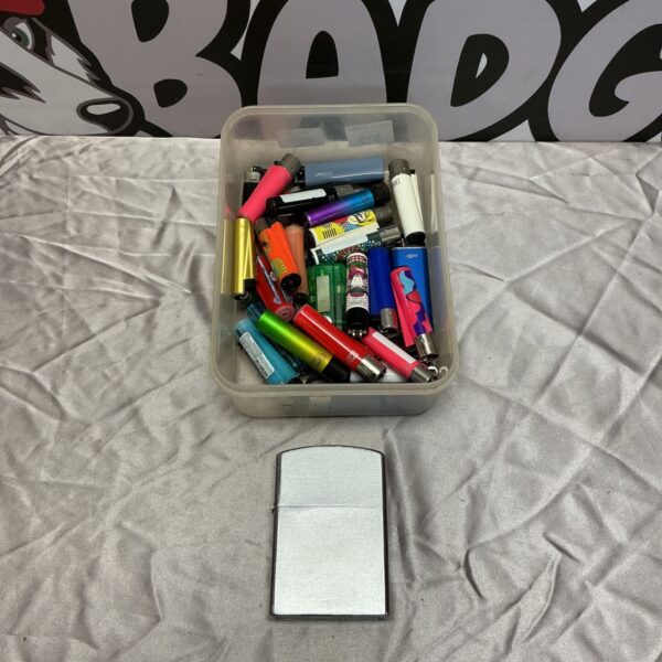Box of assorted vintage and collectible lighters.