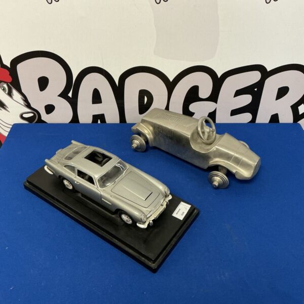 Detailed Aston Martin DB5 Goldfinger model car on display.