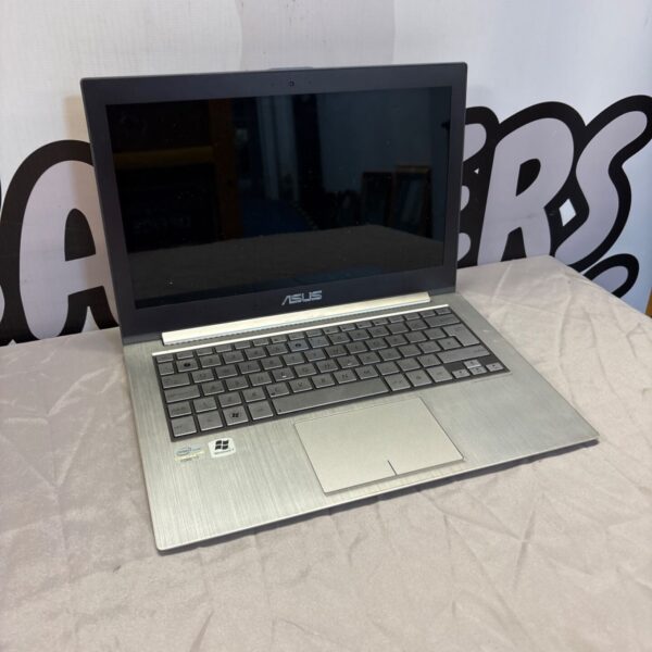 Asus QX31E laptop in untested condition, showing keyboard and screen.