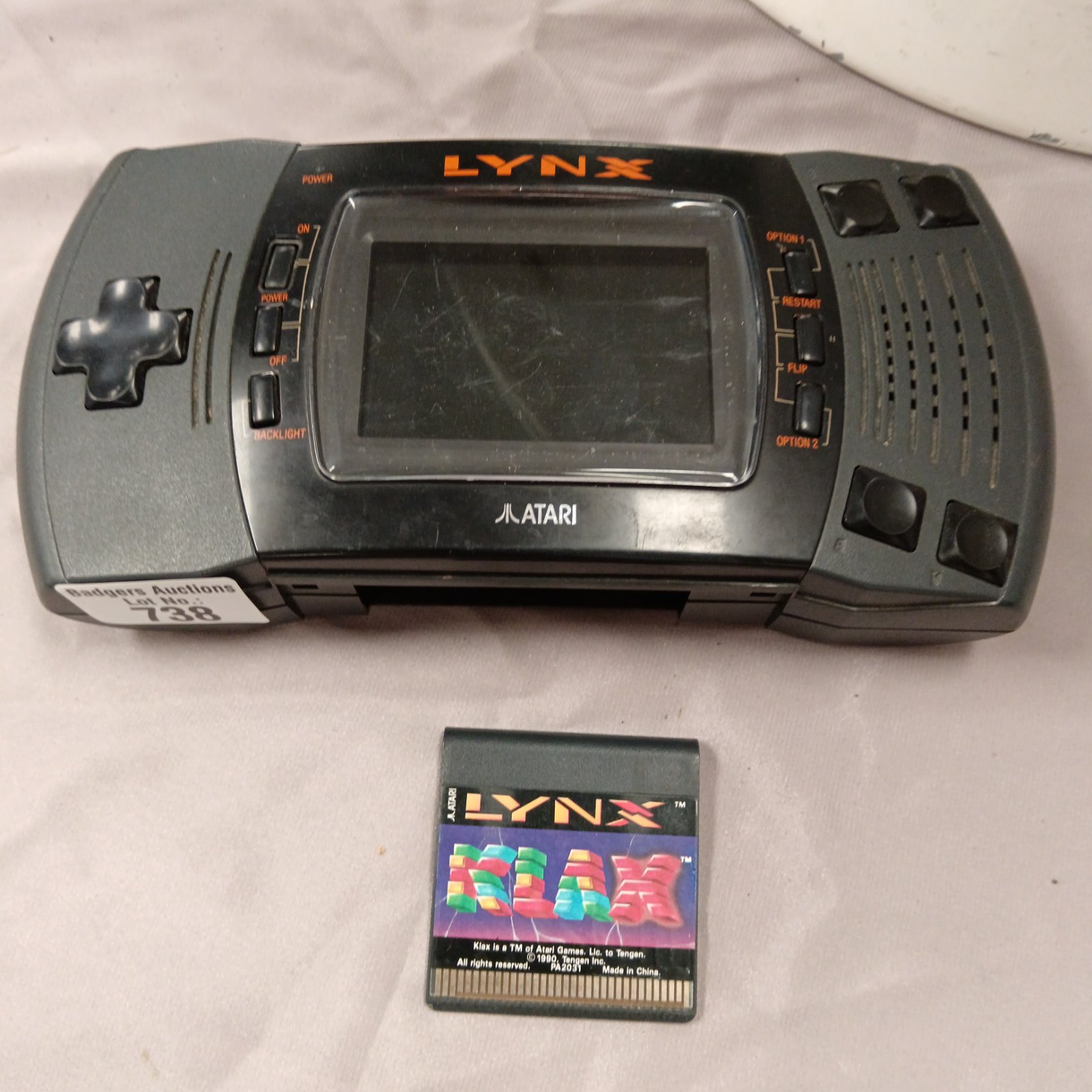 Vintage Atari Lynx handheld console with Klax game cartridge.