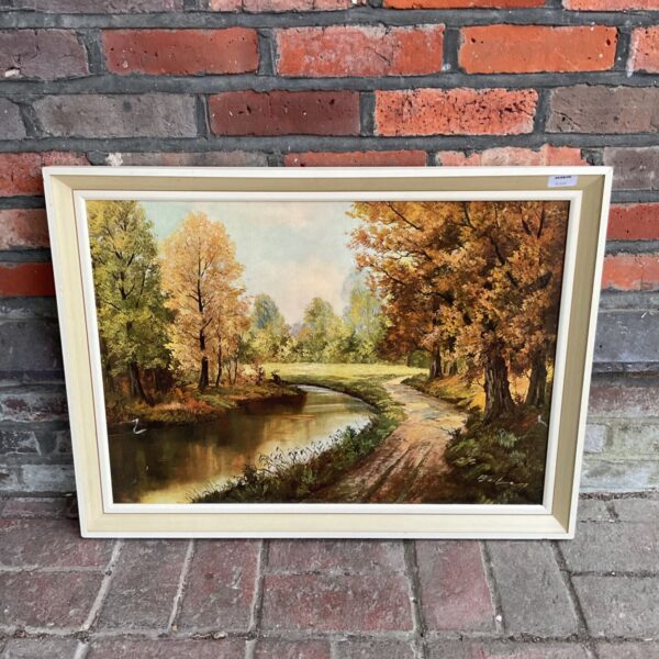 Framed autumn landscape print with winding river and golden trees.