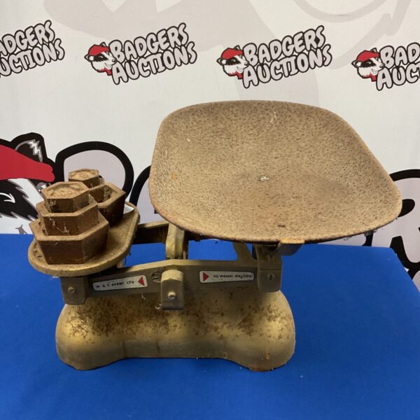 Vintage W & T Avery cast iron scales with brass weights for accurate measurements.