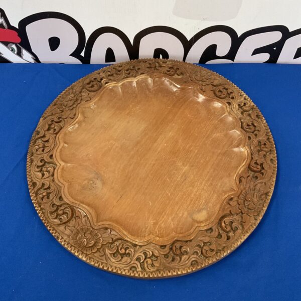 Ornate hand-carved Balinese serving tray with floral details.
