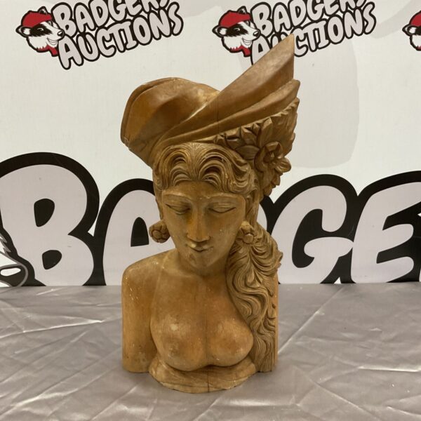 Hand-carved Balinese wood carving of a nude woman's bust.