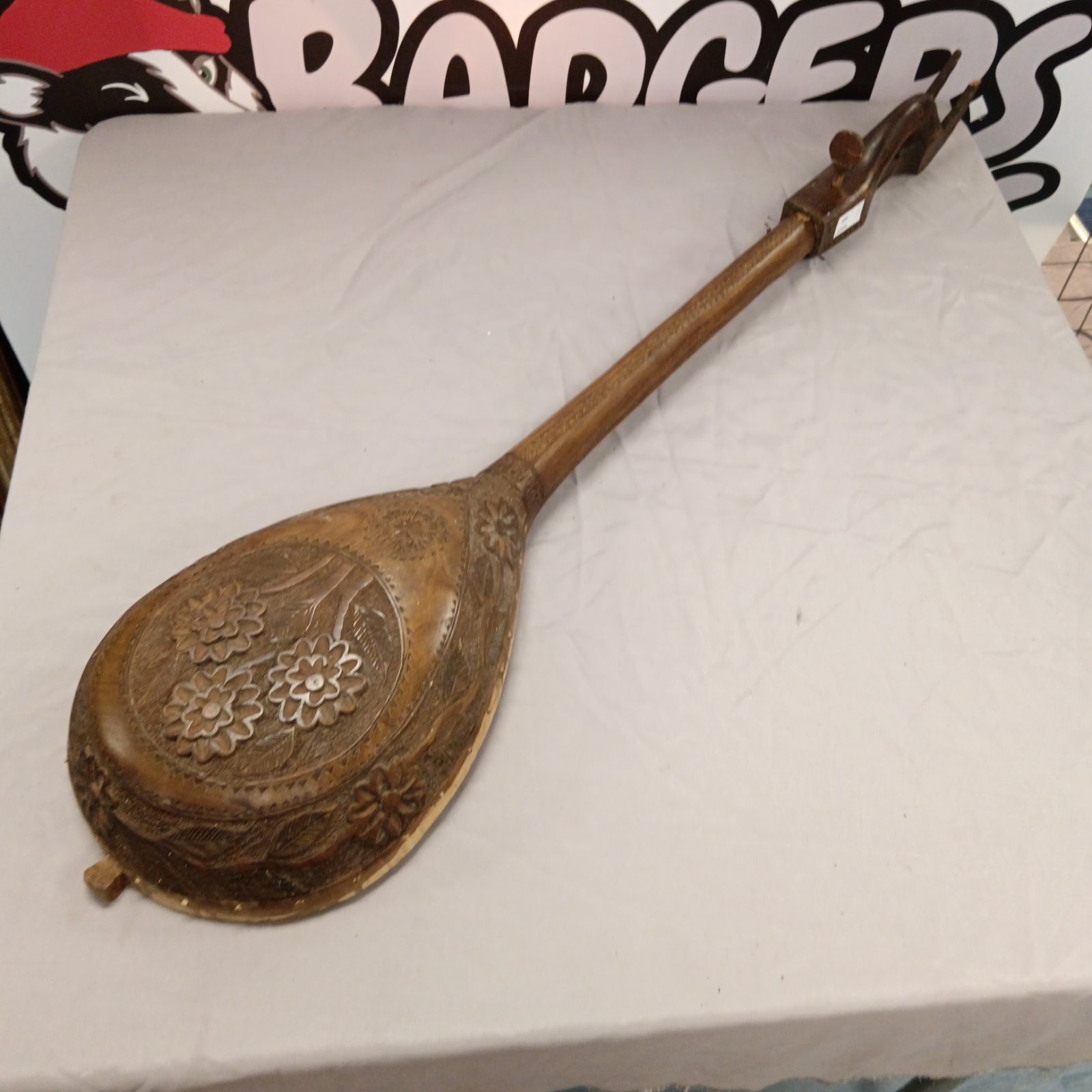 Carved Balkan gusle with floral designs, a traditional folk instrument.
