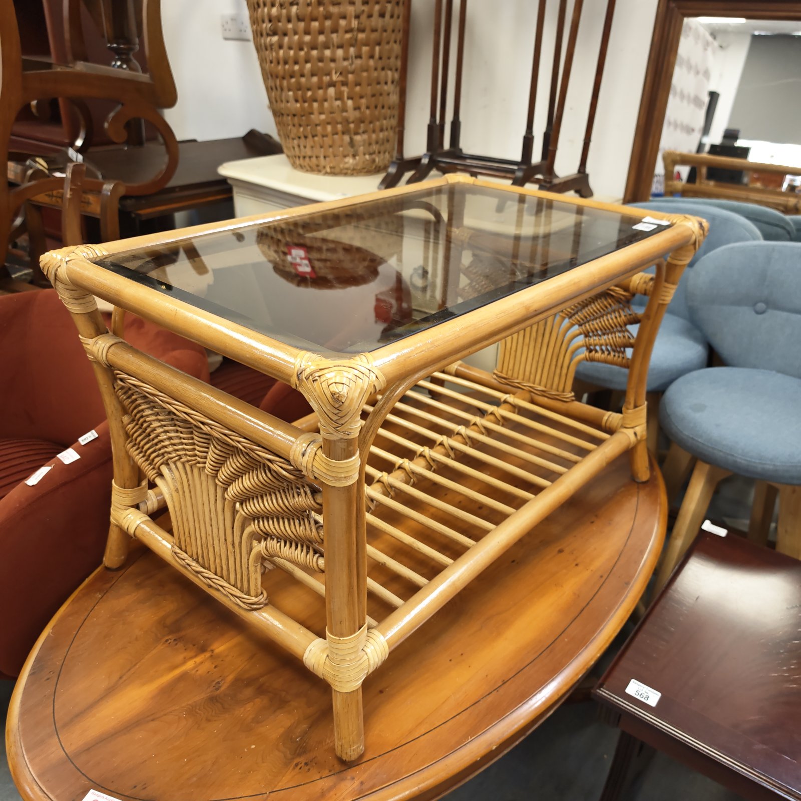 Vintage bamboo coffee table with a glass top and natural finish.