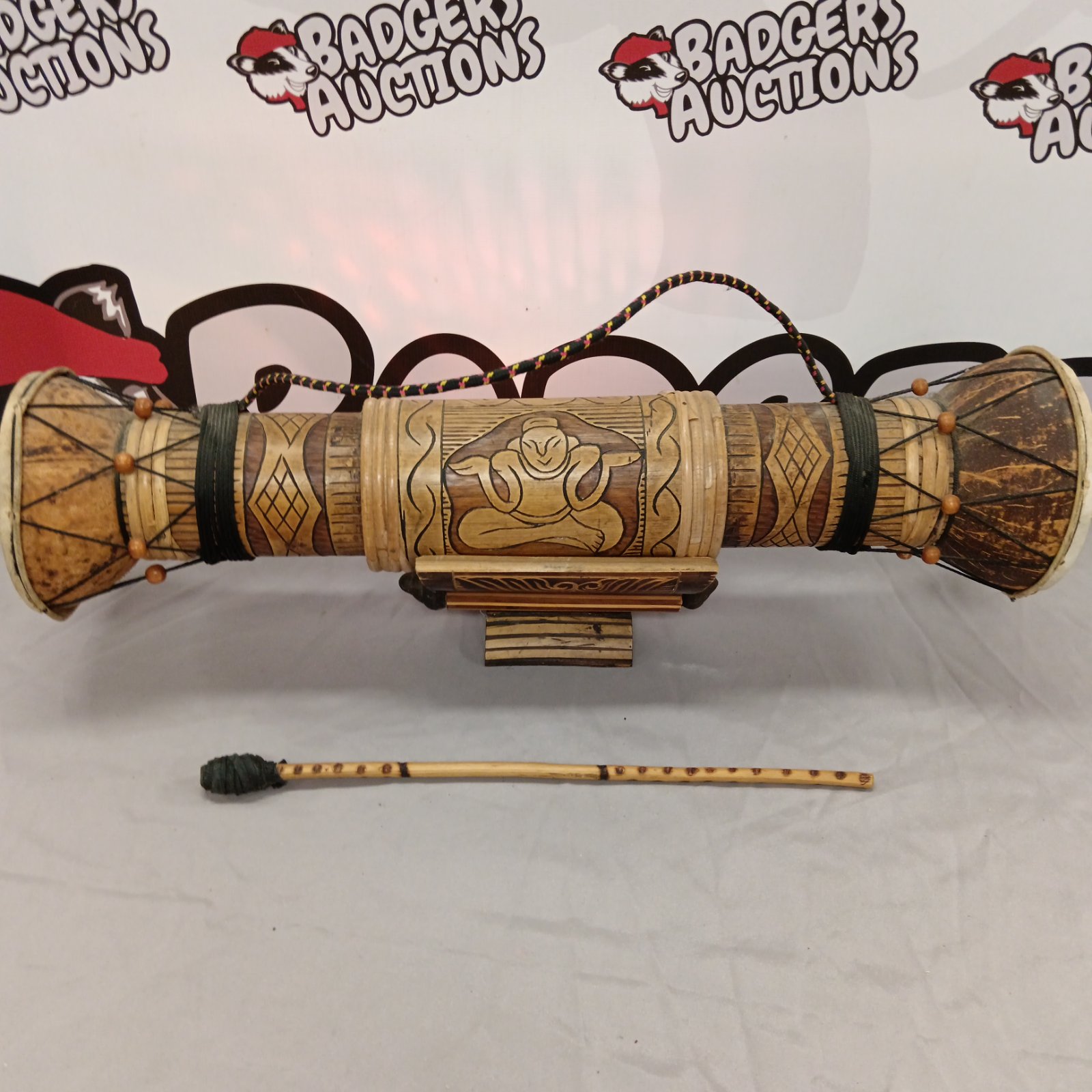 Intricately carved bamboo temple drum with colourful tassels.