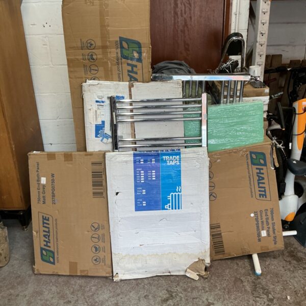 Job lot of white bath panels and towel radiators for bathroom renovation.