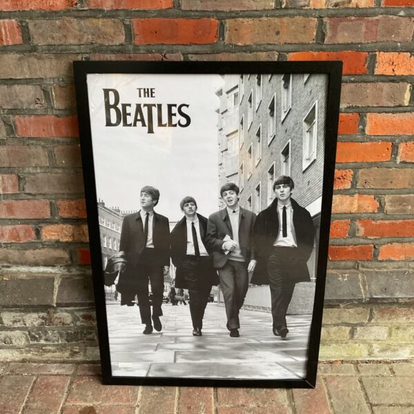 Large framed Beatles Abbey Road poster for music room decor.