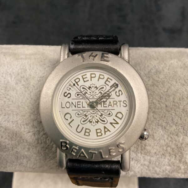 Beatles Sergeant Pepper watch with leather strap and circular dial.
