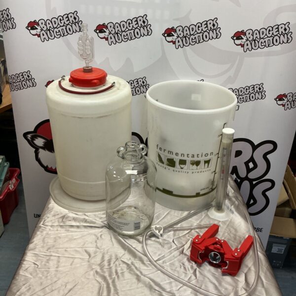 Beer brewing equipment set including fermenters and carboy.