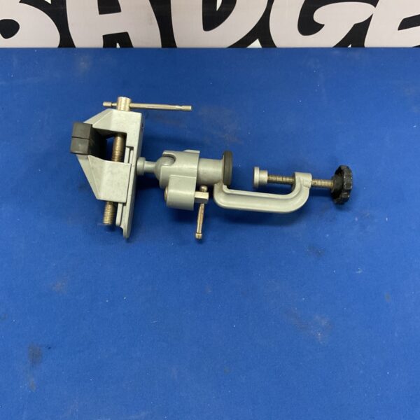 Metal bench vise with swivel base for workshop use.