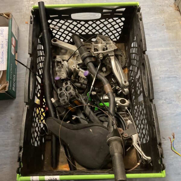 Tray of mixed bike parts including handlebars and brake levers.