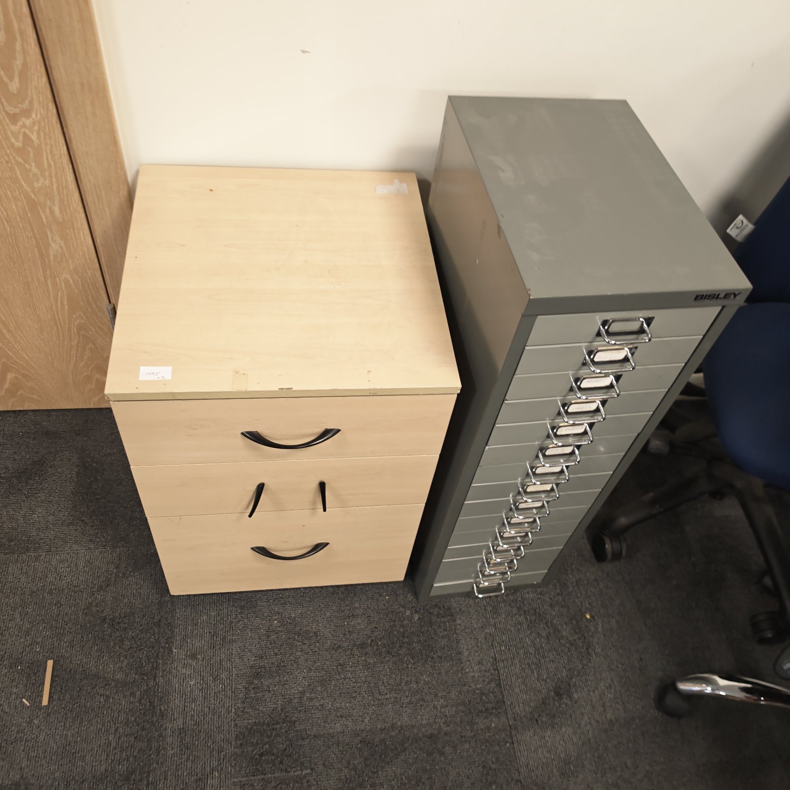 Bisley engineers cabinet with wooden top and metal drawers.