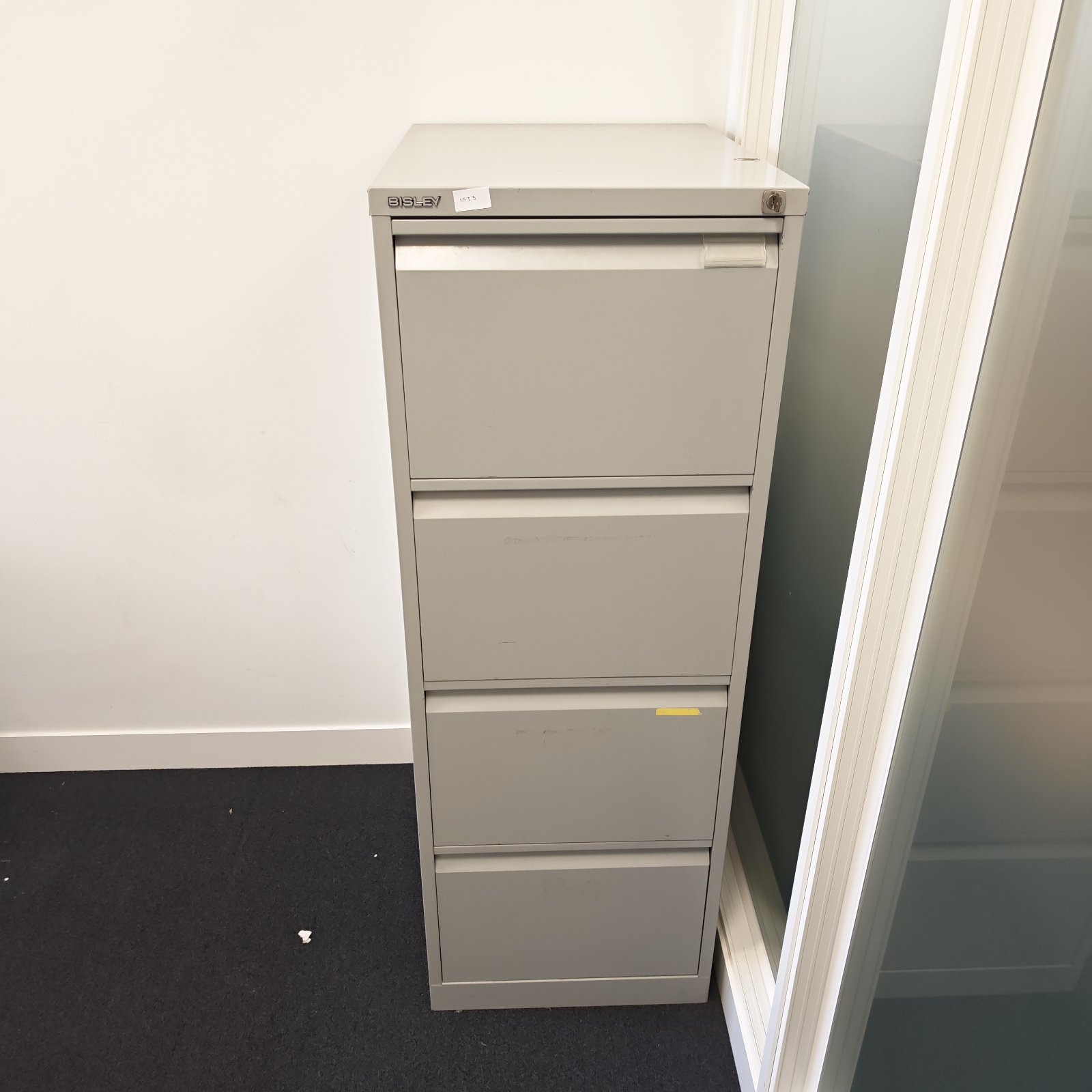 Front view of a grey Bisley four drawer filing cabinet.