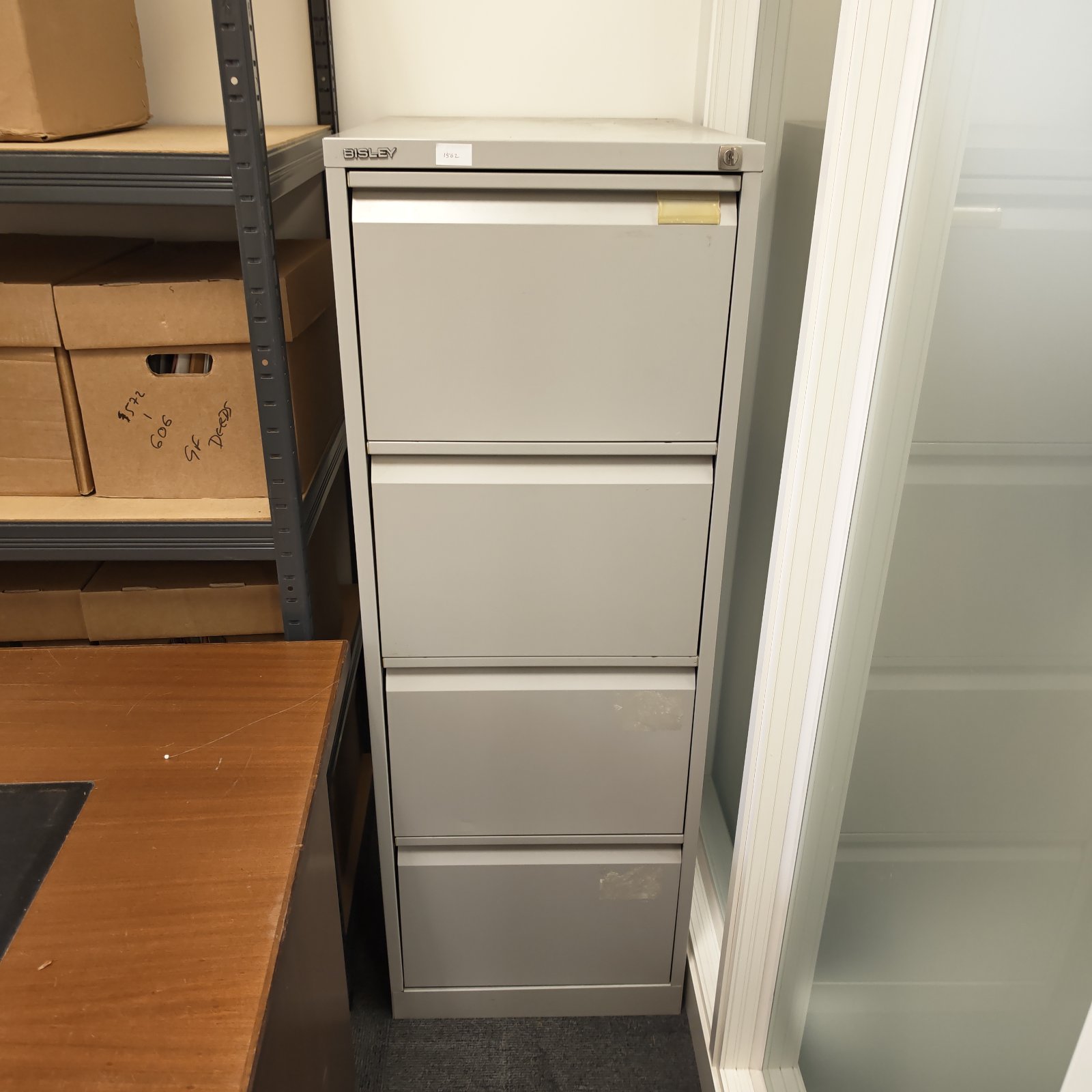 Grey Bisley filing cabinet with four drawers, vintage office storage.