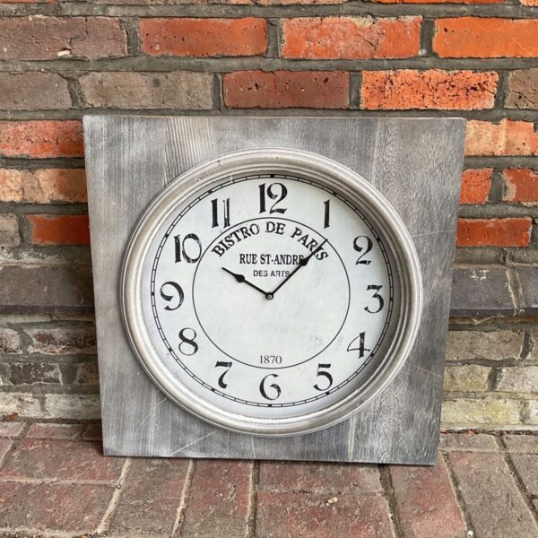 Large vintage Bistro de Paris Rue St-Andre wall clock with black numerals.