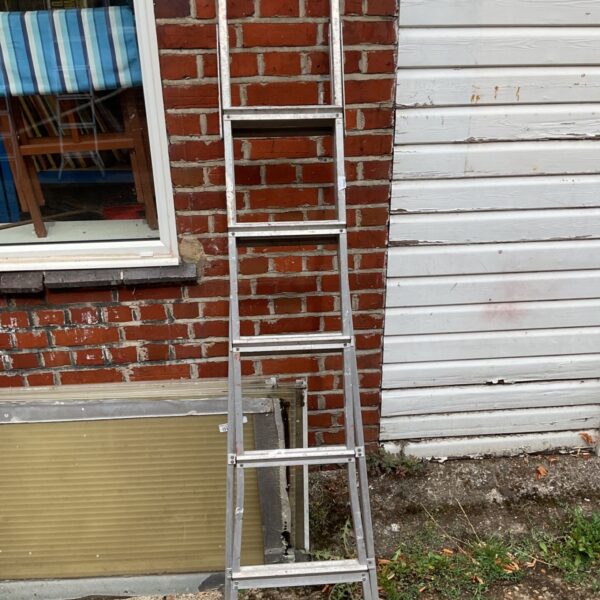 Black and Decker 3-way ladder leaning against a wall.