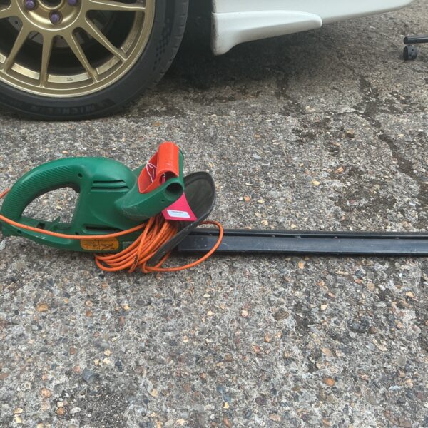 Used Black and Decker electric hedge trimmer for garden maintenance.