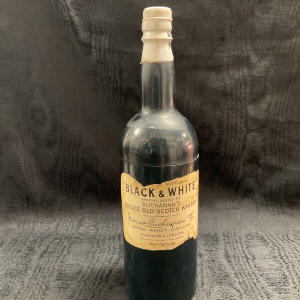 Vintage Black and White Buchanan’s whiskey bottle musical cigarette dispenser.