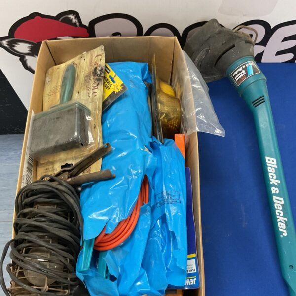 Black & Decker electric grass trimmer in a mixed tool lot.
