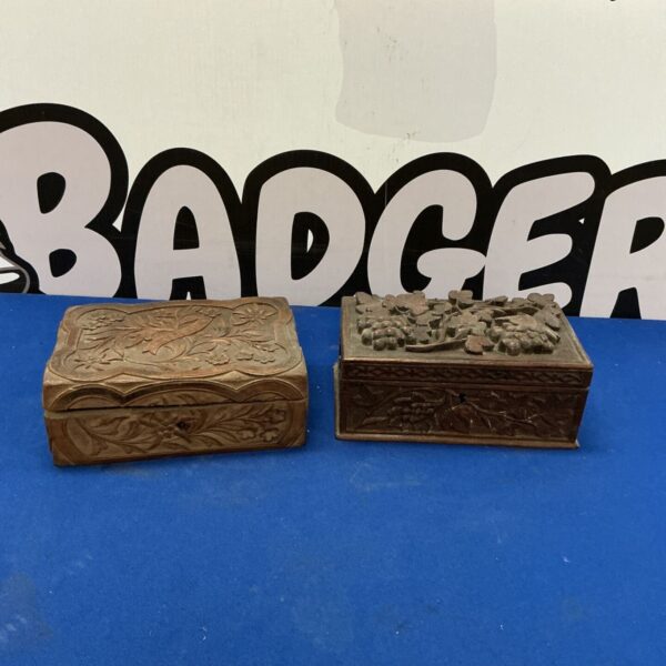 Antique Black Forest carved wooden trinket boxes with floral details.