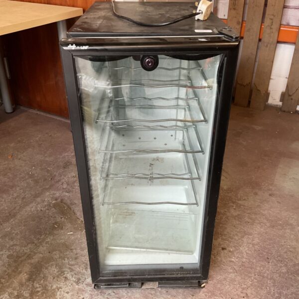 Black mini fridge with glass door and wire racks.