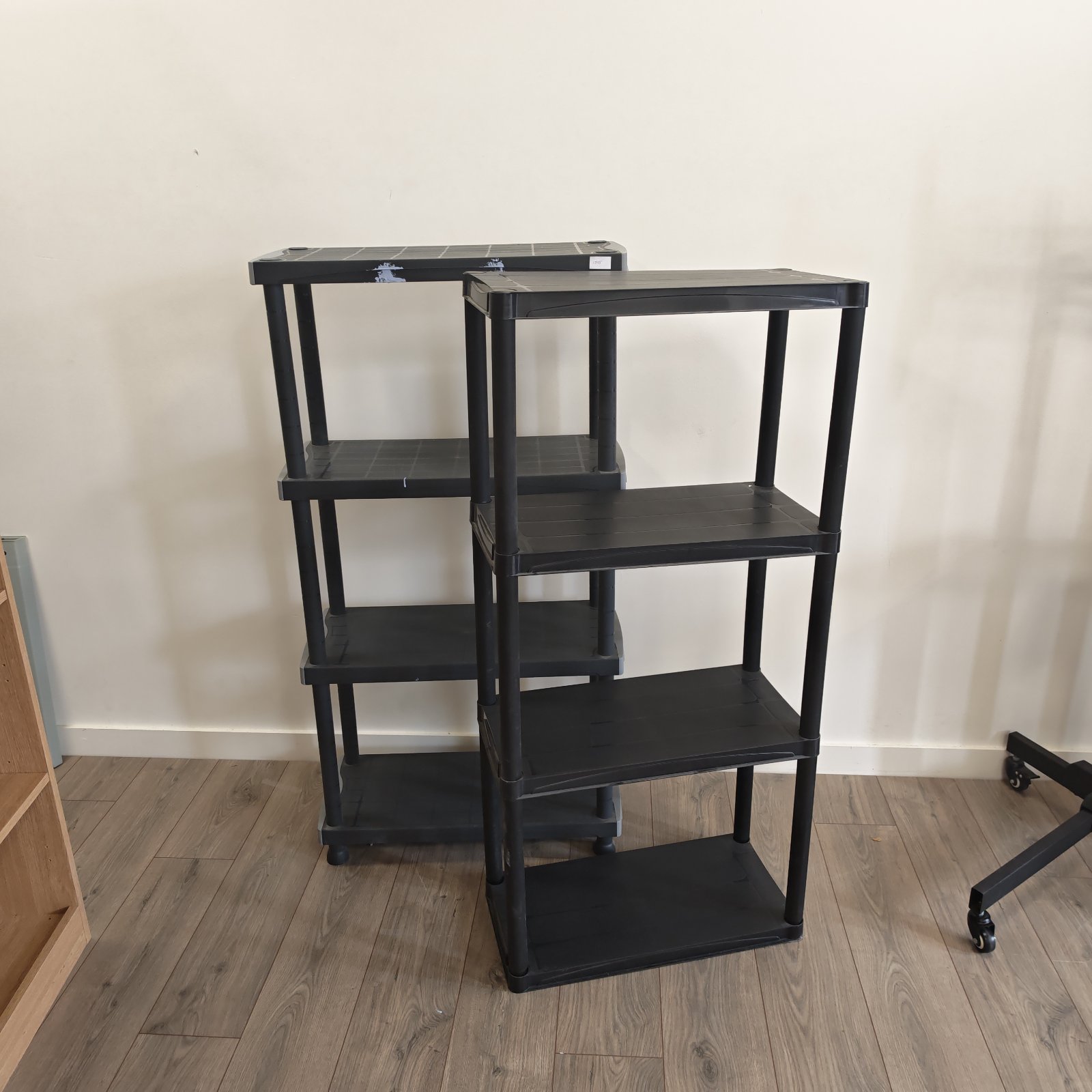 Black plastic storage shelving units for garage or home organization.