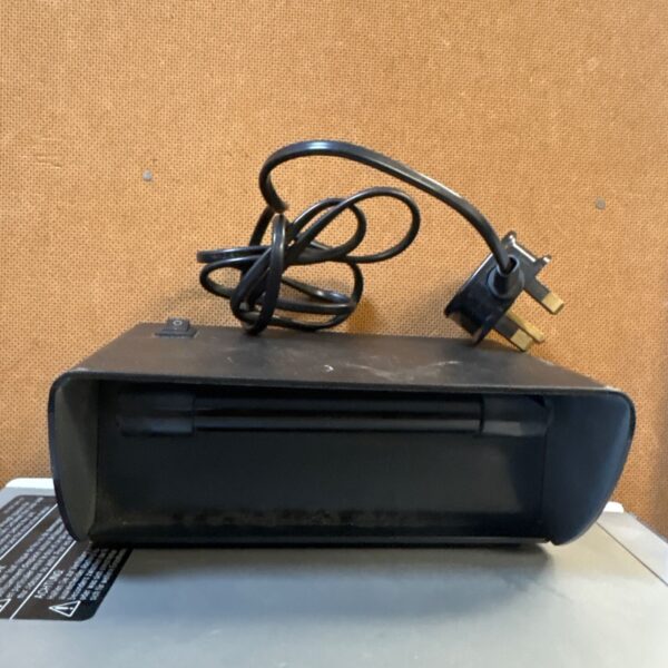 Vintage blacklight lamp with power cable visible.