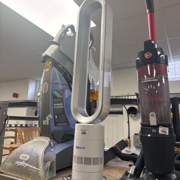 Side view of a modern bladeless pedestal fan with a vacuum cleaner.