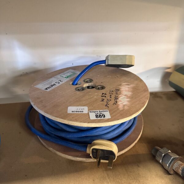 Blue Arctic 25m extension reel with single plug, showing signs of use.