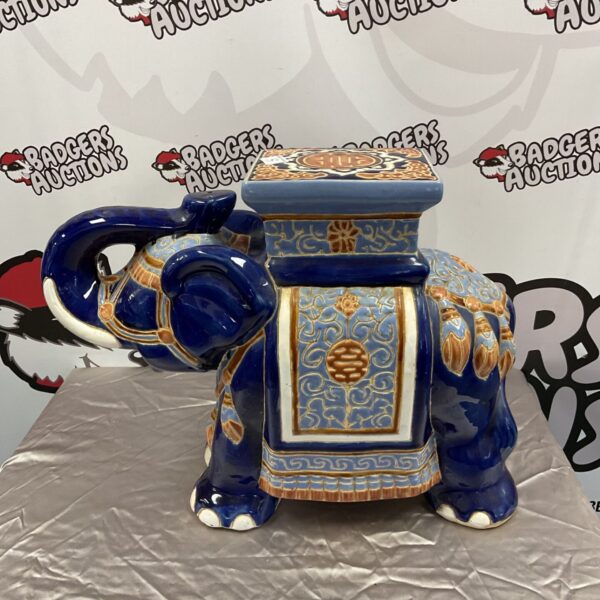Detailed blue ceramic elephant jardiniere stand for plants.